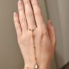 Chaîne de main en acier inoxydable doré, ornée d’une khamsa nacrée lumineuse, pour une touche élégante et protectrice au poignet et à la main